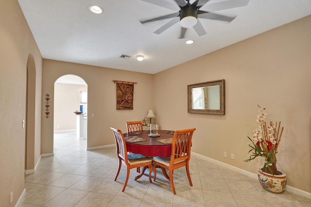 tiled dining space with ceiling fan