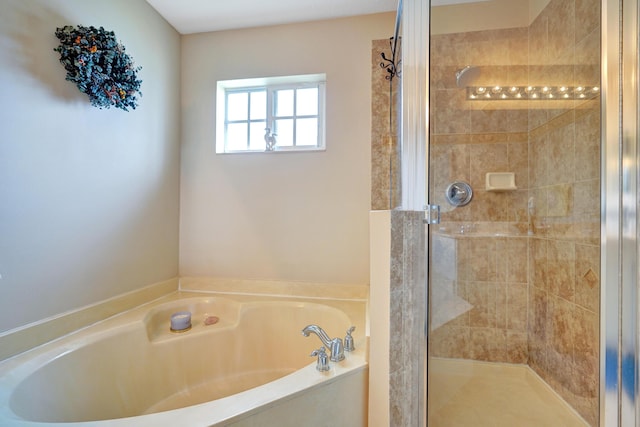 bathroom featuring shower with separate bathtub