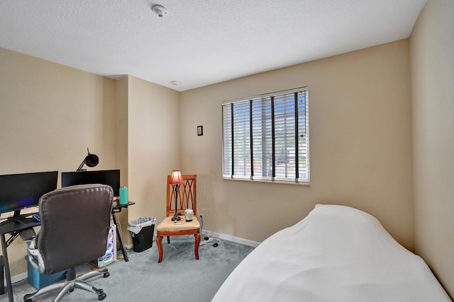 carpeted bedroom featuring a textured ceiling