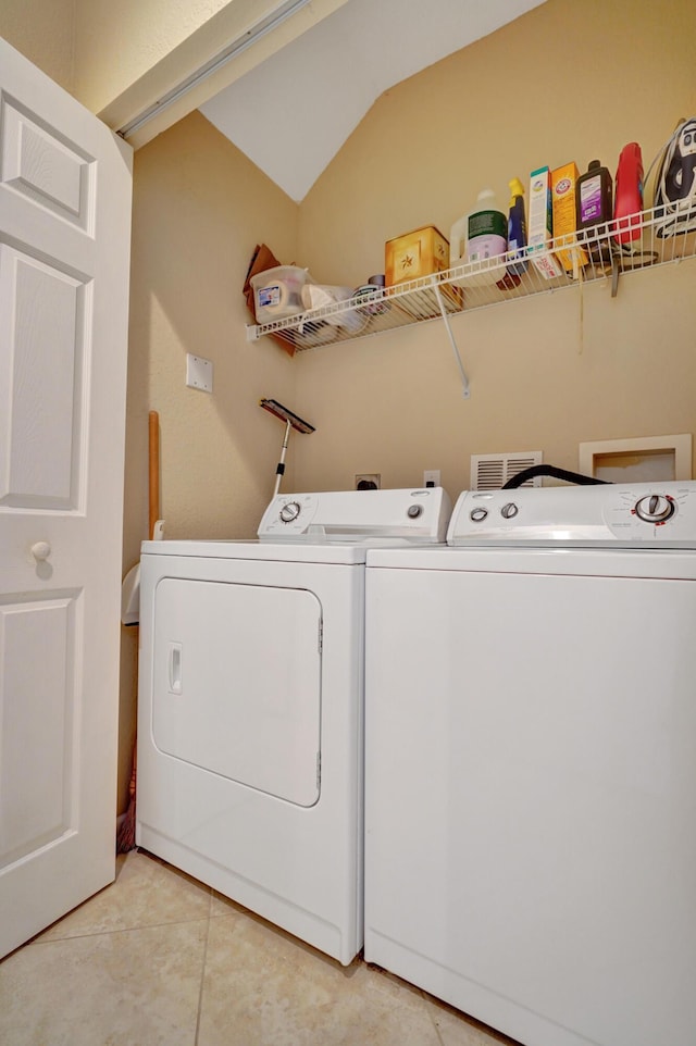 laundry room with separate washer and dryer and light tile patterned floors