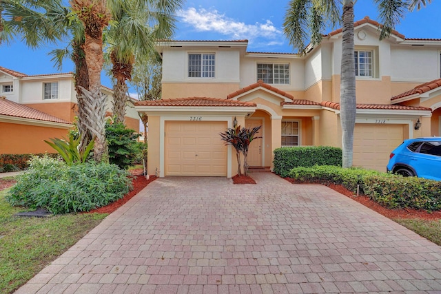 mediterranean / spanish-style home with a garage