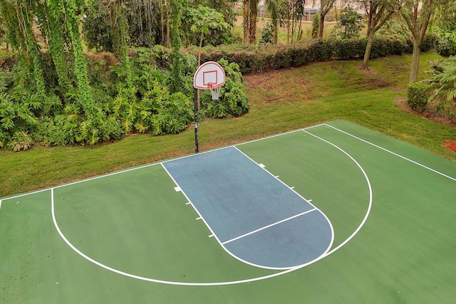 view of basketball court with a lawn