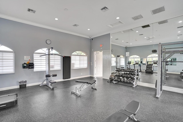 gym with ornamental molding and a healthy amount of sunlight