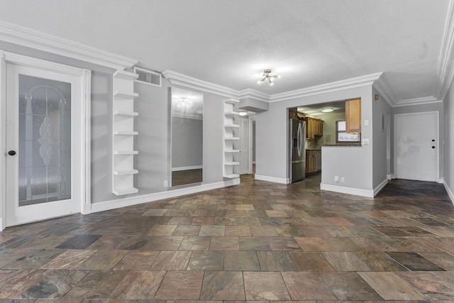 unfurnished living room featuring built in shelves, crown molding, and a textured ceiling