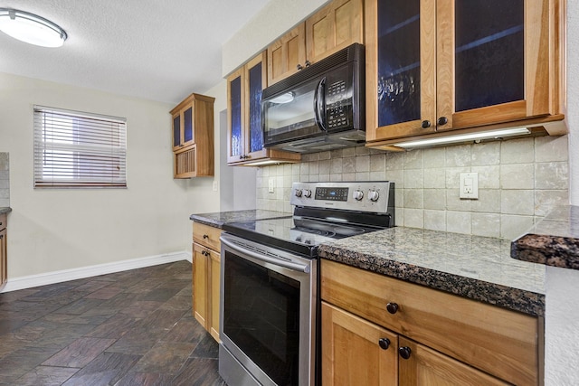 kitchen featuring backsplash, a textured ceiling, and stainless steel range with electric stovetop