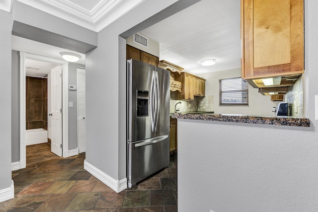 kitchen with sink, decorative backsplash, stainless steel fridge with ice dispenser, and ornamental molding