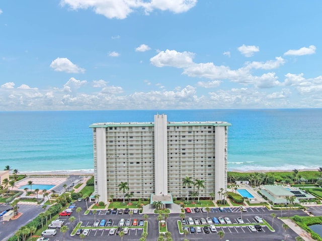 drone / aerial view featuring a water view and a view of the beach