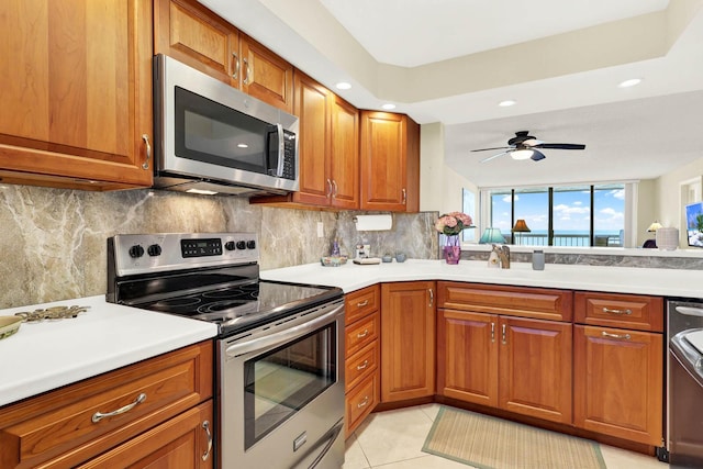 kitchen featuring ceiling fan, light tile patterned floors, backsplash, and appliances with stainless steel finishes