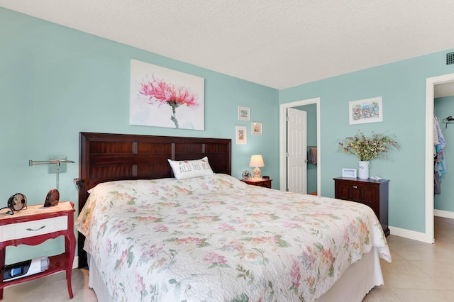 tiled bedroom with a textured ceiling