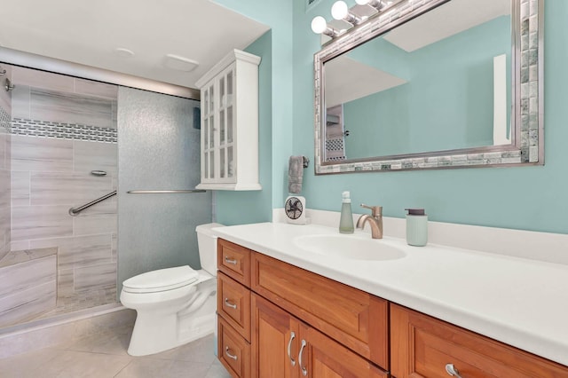 bathroom with tile patterned floors, toilet, vanity, and a tile shower