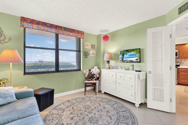 tiled living room with a textured ceiling