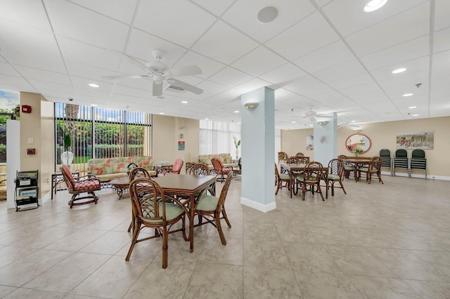 dining room featuring ceiling fan and floor to ceiling windows