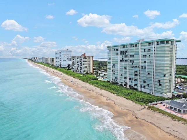 birds eye view of property featuring a beach view and a water view