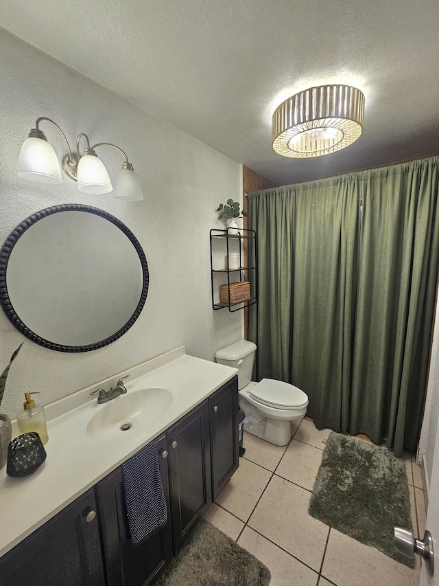 bathroom with toilet, a textured ceiling, tile patterned floors, and vanity