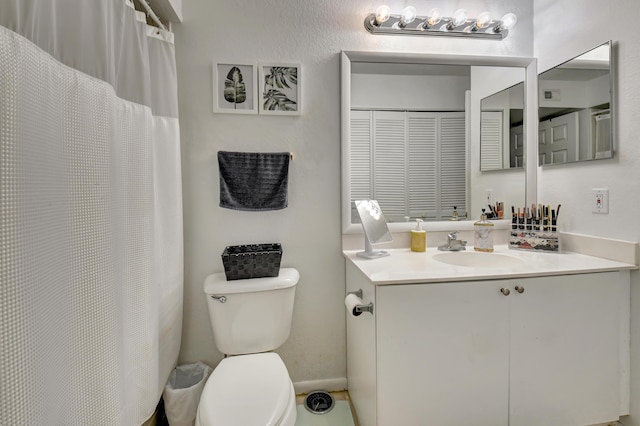 bathroom featuring toilet and vanity