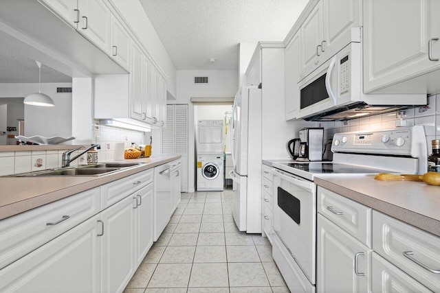 kitchen with white cabinetry, sink, white appliances, and tasteful backsplash