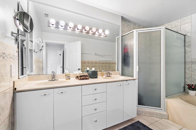 bathroom with vanity, independent shower and bath, and tile patterned flooring