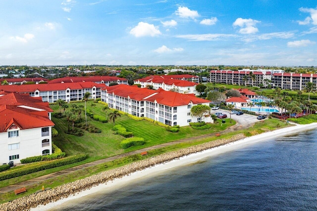 drone / aerial view featuring a view of the beach and a water view