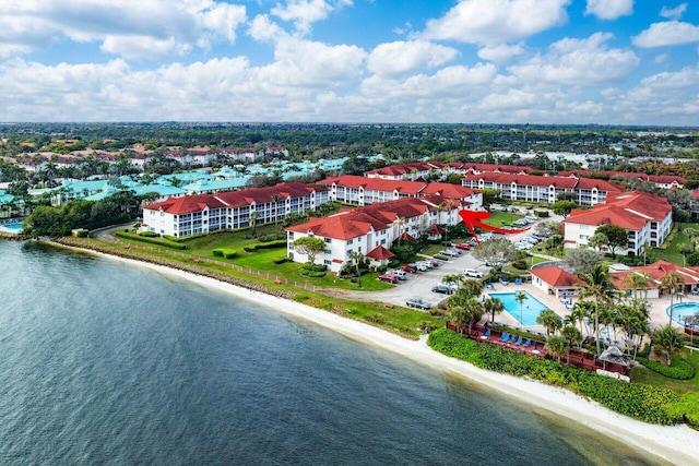 bird's eye view with a water view and a beach view