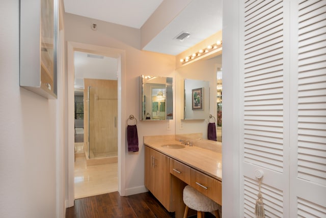 bathroom featuring vanity, wood-type flooring, and a shower