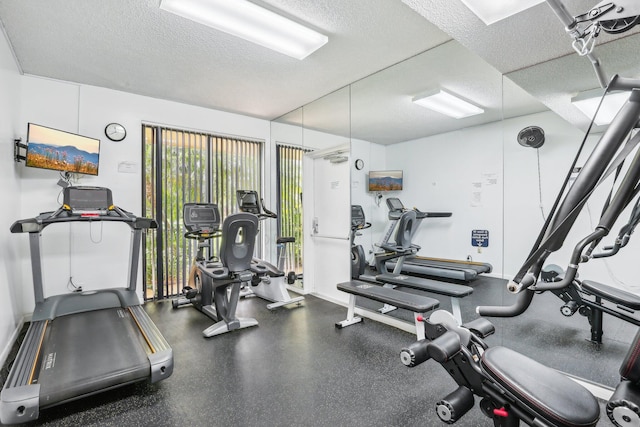 gym featuring a textured ceiling