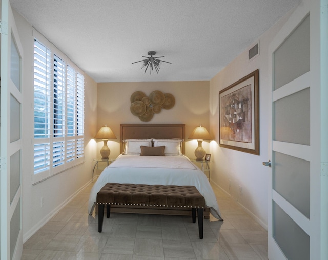 bedroom with a textured ceiling and ceiling fan