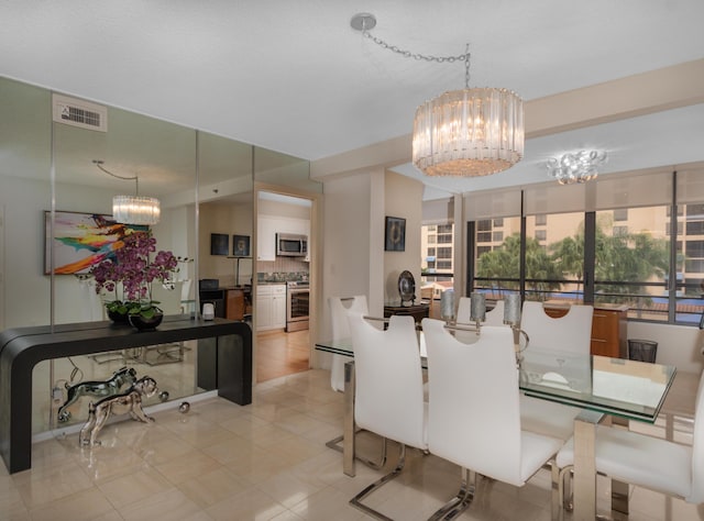 tiled dining area featuring a chandelier