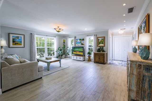 living room with crown molding and light wood-type flooring