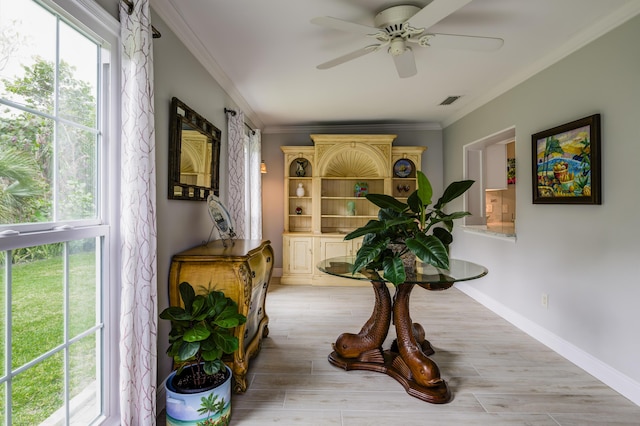 interior space featuring ornamental molding and light hardwood / wood-style floors