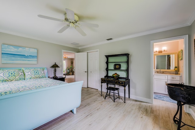 bedroom featuring crown molding, light hardwood / wood-style flooring, ceiling fan, ensuite bathroom, and a closet