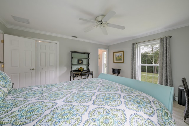 bedroom with ceiling fan, a closet, and crown molding