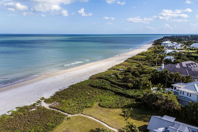 drone / aerial view featuring a water view and a view of the beach