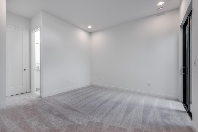 empty room featuring light colored carpet