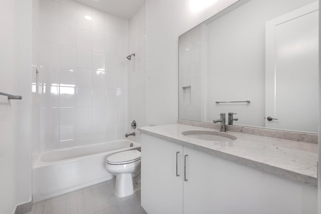 full bathroom with toilet, tiled shower / bath, tile patterned floors, and vanity