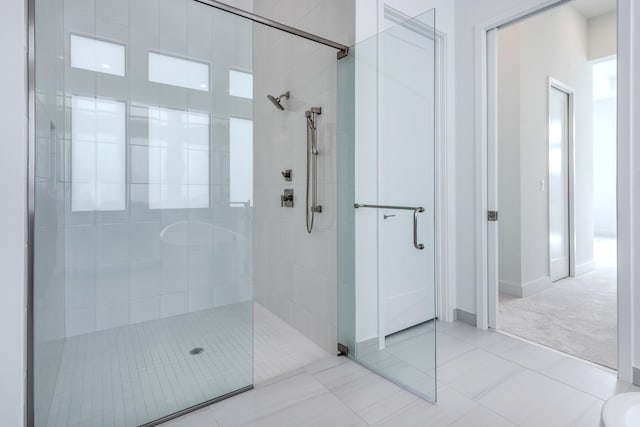 bathroom featuring tile patterned floors and an enclosed shower