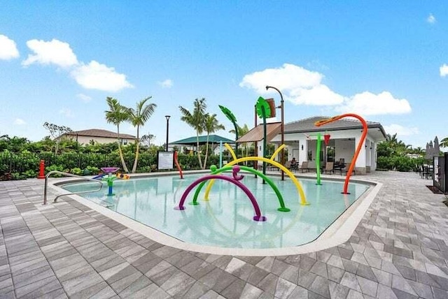 view of swimming pool featuring a playground