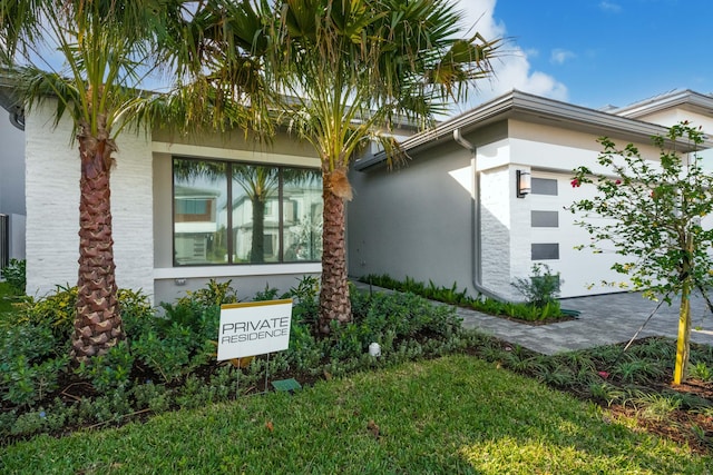 view of property exterior featuring a lawn