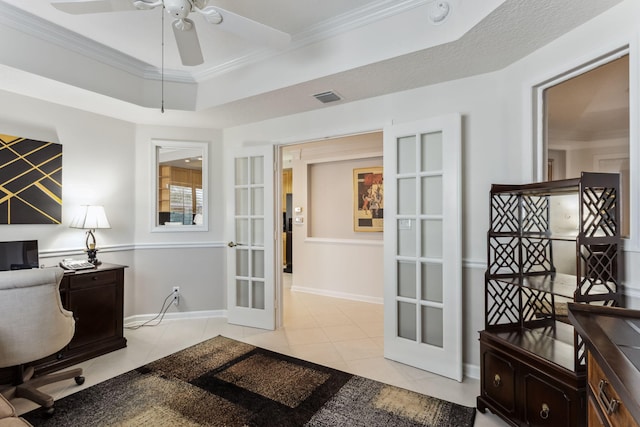 tiled office with a tray ceiling, ornamental molding, french doors, and ceiling fan