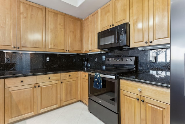 kitchen with electric stove, light tile patterned floors, stainless steel fridge, tasteful backsplash, and dark stone counters