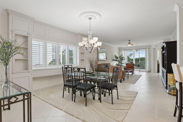 tiled dining area featuring crown molding, ceiling fan with notable chandelier, and a textured ceiling