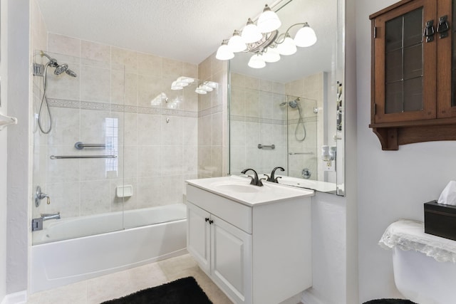 bathroom featuring tile patterned floors, shower / bath combination with glass door, vanity, and a textured ceiling