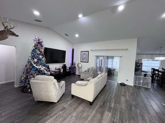 living room featuring vaulted ceiling and dark hardwood / wood-style flooring