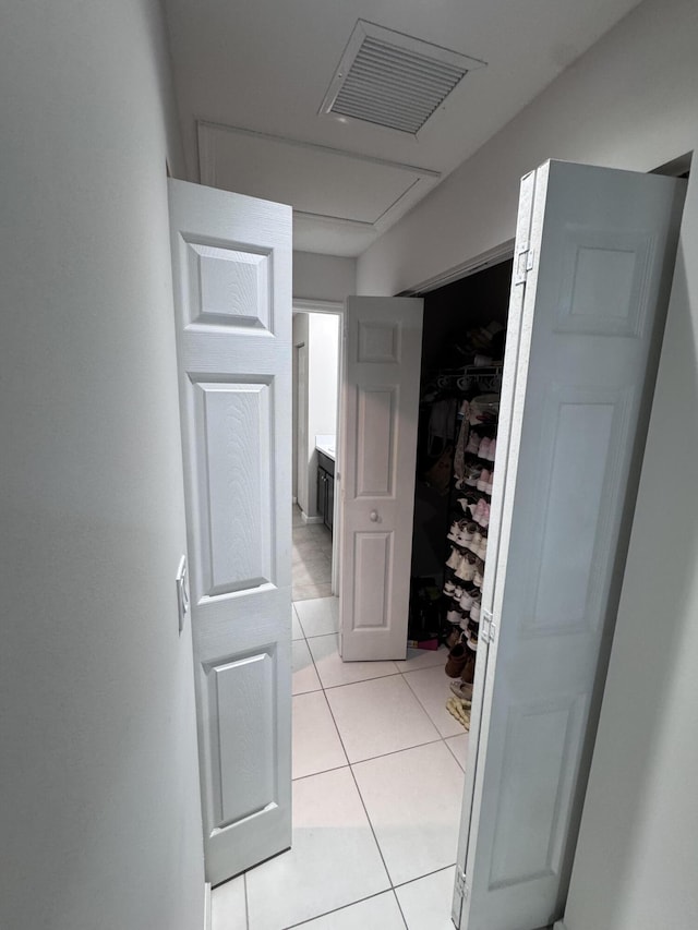 corridor featuring light tile patterned floors