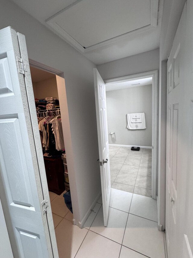 hall featuring light tile patterned floors