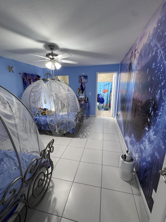 tiled bedroom with ceiling fan and a textured ceiling