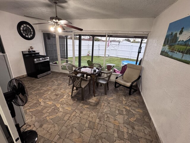 dining room featuring ceiling fan and a textured ceiling