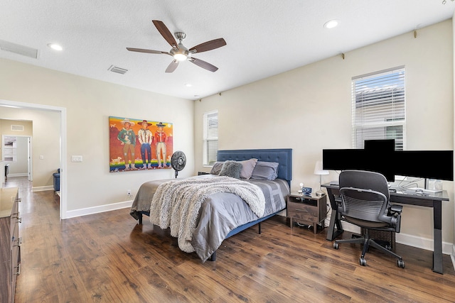 bedroom featuring dark wood-type flooring, ceiling fan, a textured ceiling, and multiple windows