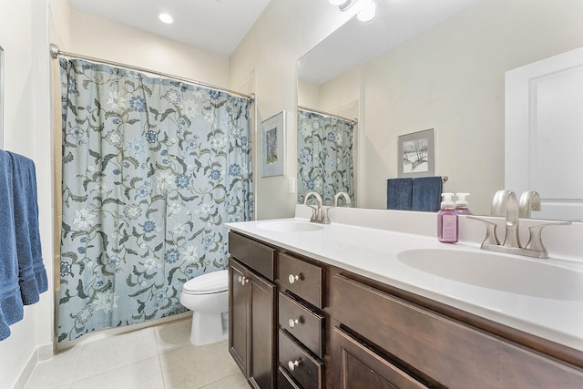 bathroom featuring toilet, vanity, a shower with shower curtain, and tile patterned flooring