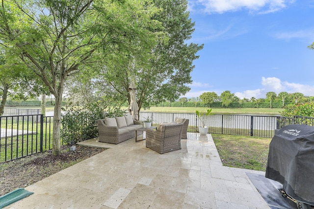 view of patio / terrace with a water view, an outdoor living space, and area for grilling