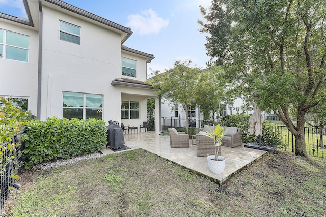 rear view of house with an outdoor living space and a patio